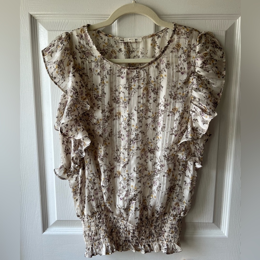 Whimsical floral sleeveless top with ruffles and elastic bottom